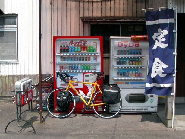 Brodie bike parked beside vending machines in front of restaurant